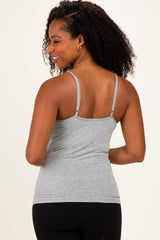 woman wearing a gray fitted tank top with thin straps, viewed from the back