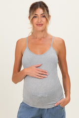 woman wearing a grey maternity tank top and holding her baby bump