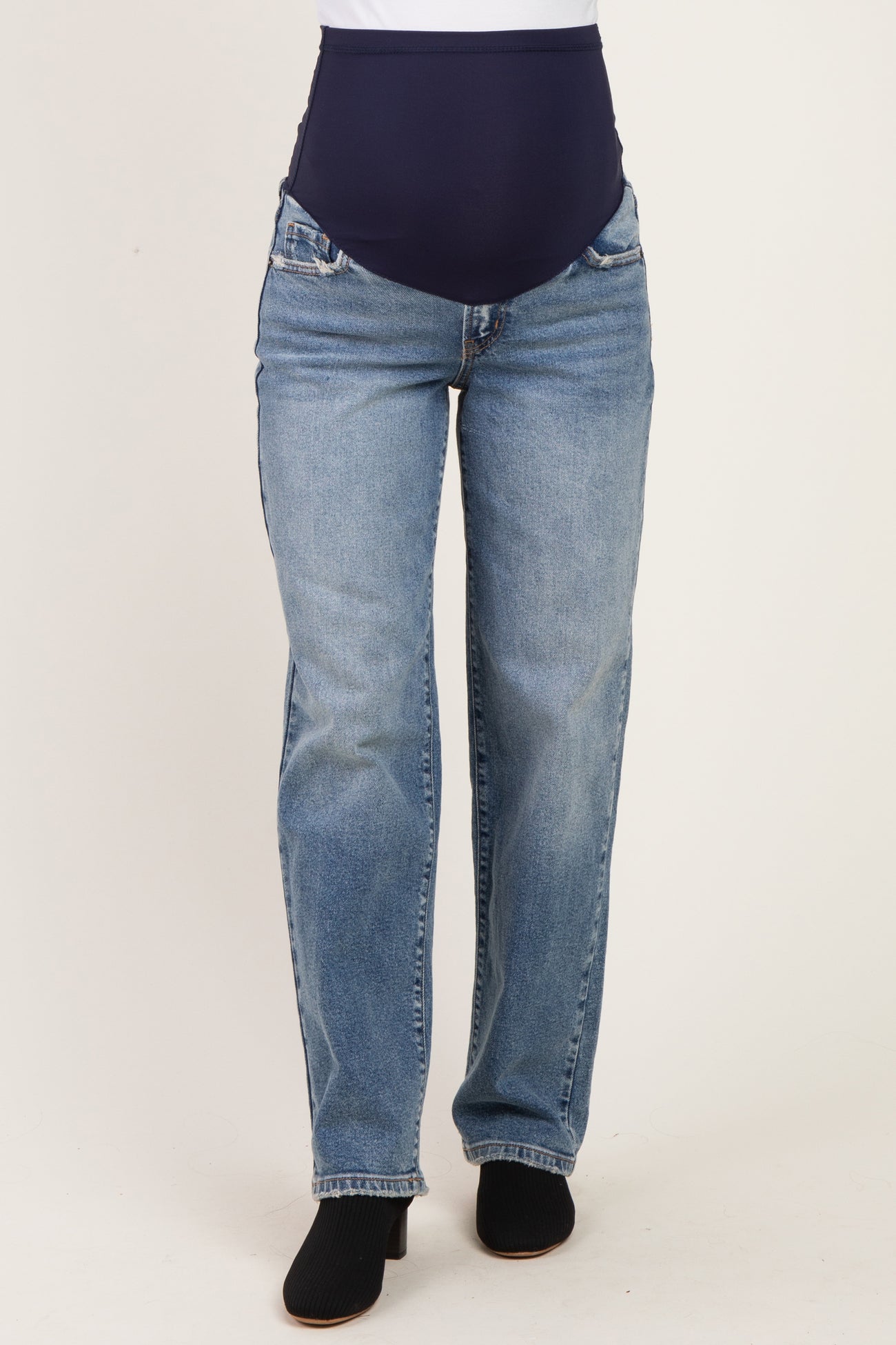 woman wearing blue maternity jeans with a dark blue over-the-bump panel and straight leg style