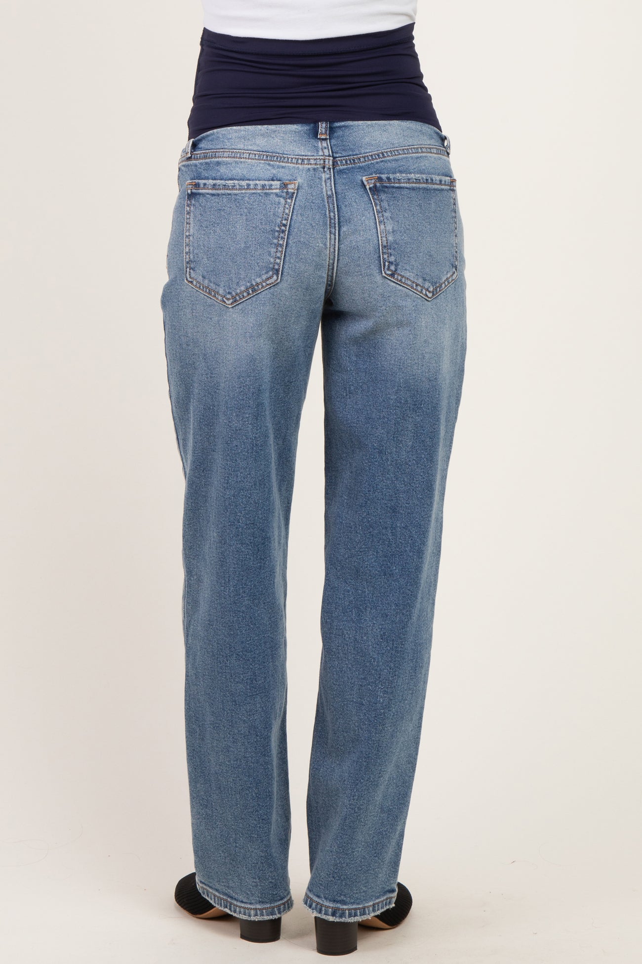 maternity wear light wash denim jeans with a stretchable waistband, shown from the back