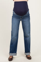 woman wearing a pair of maternity jeans with a dark blue over-the-bump panel and cuffed hem