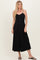 woman wearing a black button-up midi dress with adjustable straps and a flowy fit