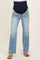 woman wearing light blue maternity jeans with a dark blue over-the-bump waistband and brown sandals