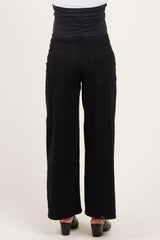 woman wearing black wide-leg maternity pants, showing the back view and a supportive waistband