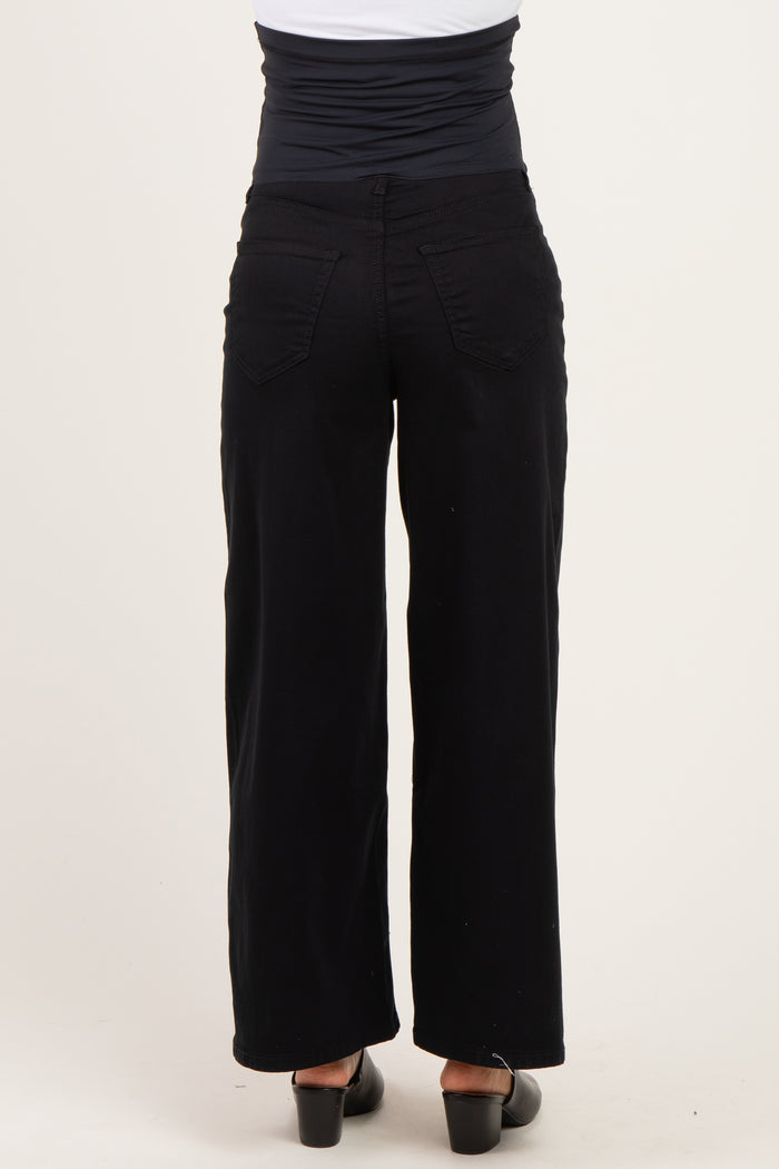 woman wearing black wide-leg maternity pants, showing the back view and a supportive waistband