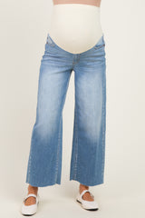 woman wearing light blue maternity wide-leg jeans with a beige over-the-bump band