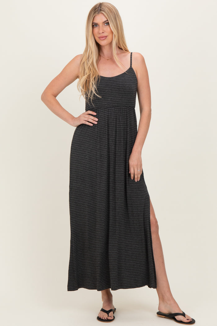 woman wearing a black and gray striped maxi dress with a side slit and spaghetti straps