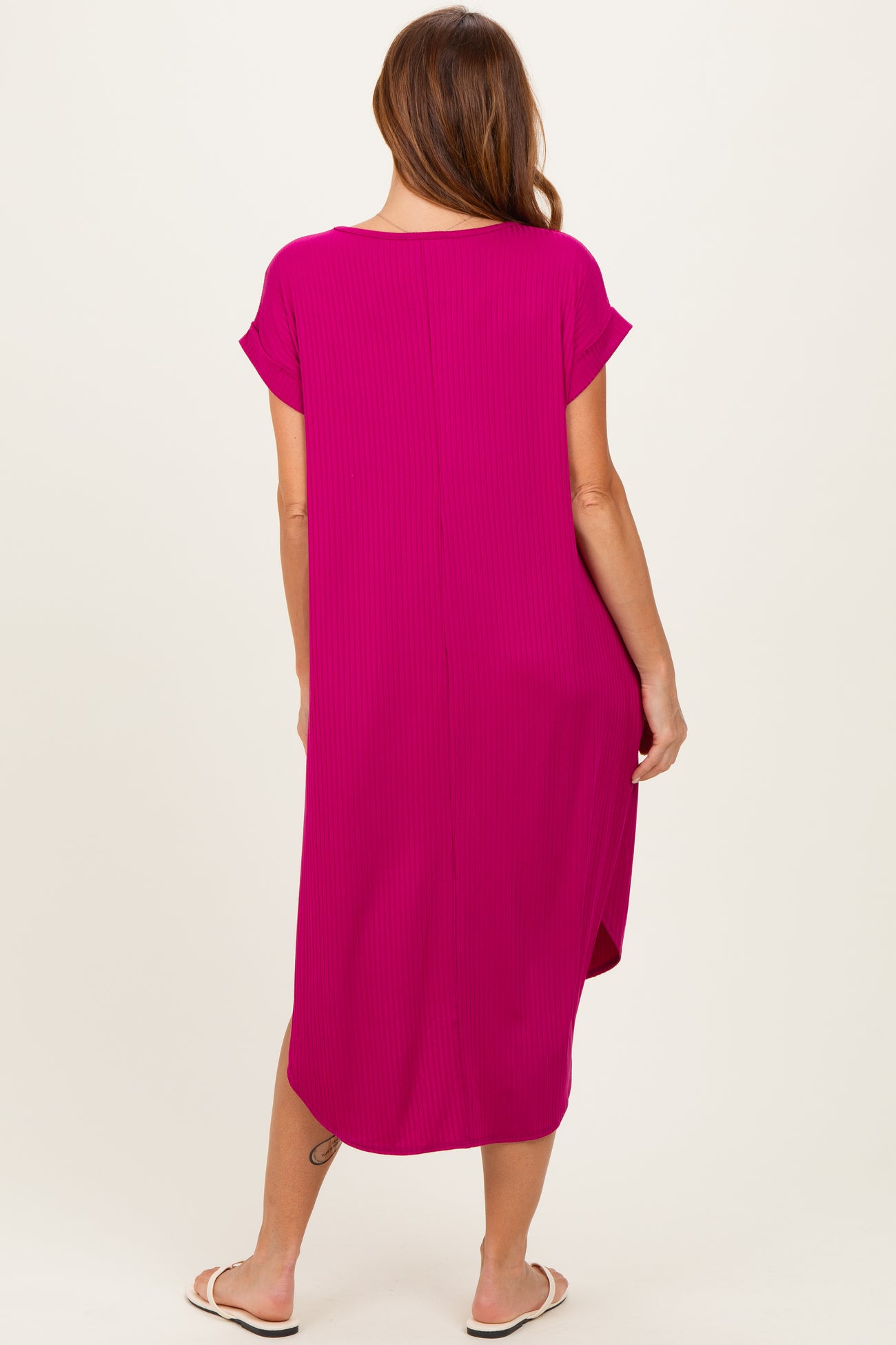 woman wearing a hot pink short sleeve maxi dress with a relaxed fit, viewed from the back