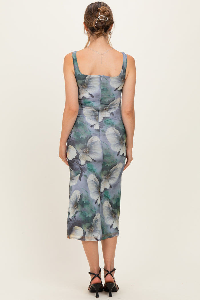 woman wearing a floral print maternity midi dress with a fitted silhouette and square neckline, viewed from the back