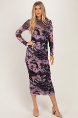 woman wearing a long sleeve purple and pink abstract print midi dress and nude heels