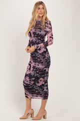 woman wearing a long sleeve pink and black animal print maxi dress