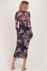 woman wearing a long sleeve bodycon dress in a purple and black abstract print, showing a form-fitting silhouette