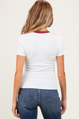 woman wearing a white ribbed maternity t-shirt with a red and navy striped neckline, viewed from the back