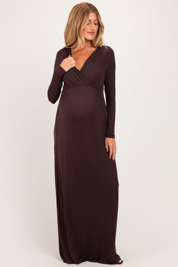 woman wearing a brown long sleeve maternity dress with a wrap style and a visible baby bump
