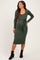 woman wearing a dark green long sleeve maternity dress with a tie waist and showcasing her baby bump