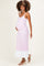 woman wearing a light pink maternity maxi dress with white detailing and showing her baby bump