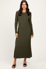woman wearing a long sleeve olive green ribbed maxi dress with a fitted silhouette and side slits