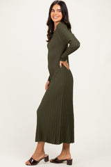 woman wearing a dark green ribbed midi dress with long sleeves and a flattering fit