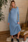 woman wearing a light blue long sleeve ribbed maternity dress with a visible baby bump