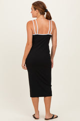 woman wearing a black midi slip dress with white straps, shown from the back