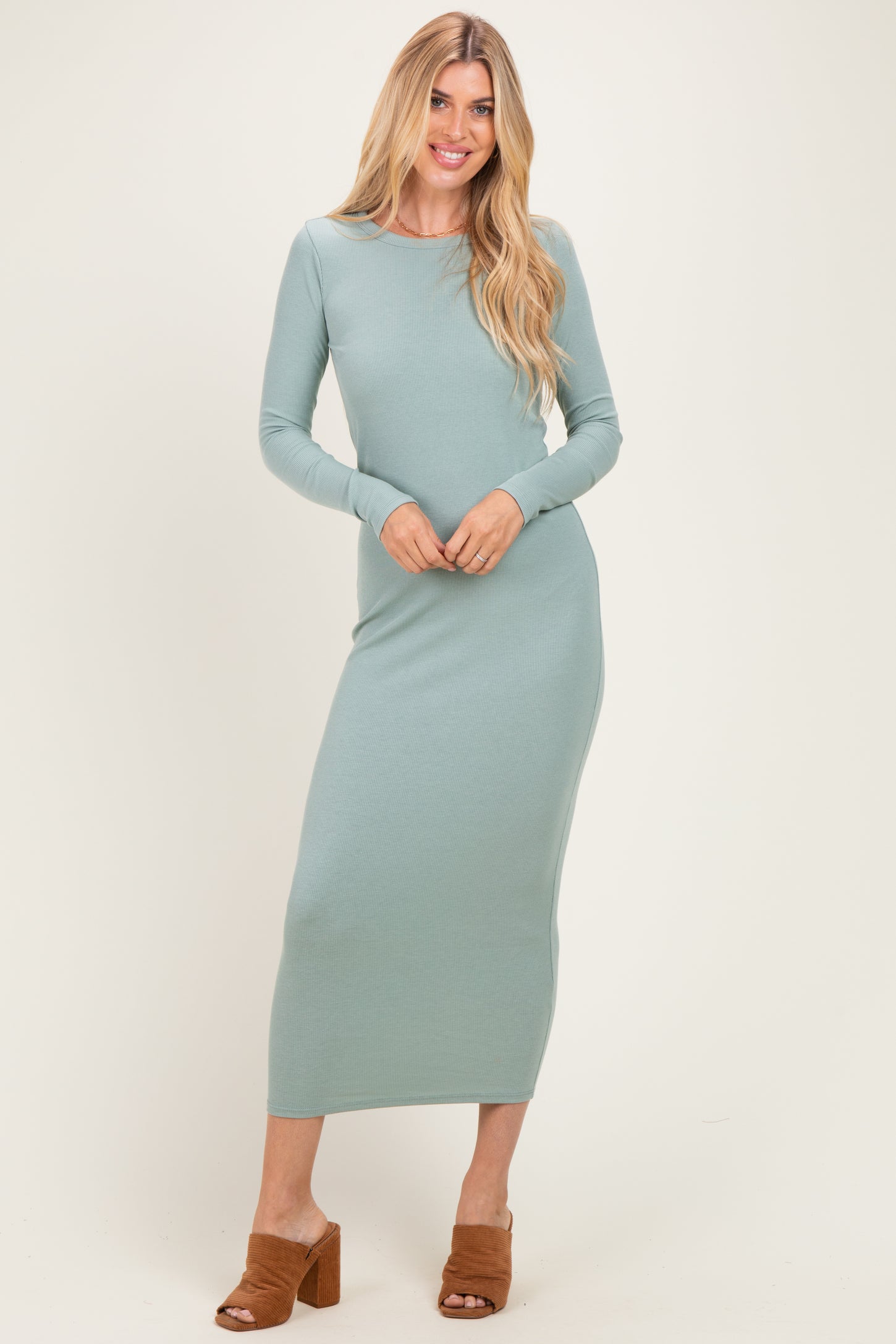 woman wearing a fitted long sleeve mint green ribbed maxi dress and brown heeled mules