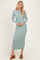 woman wearing a fitted long sleeve mint green ribbed maxi dress and brown heeled mules