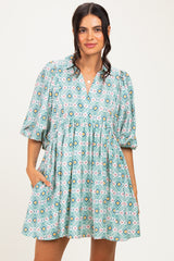 woman wearing a colorful printed short sleeve dress with a v-neck and pockets