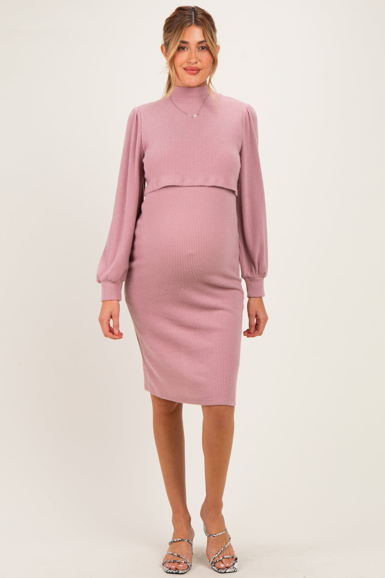 woman wearing a light purple ribbed long sleeve maternity dress with a fitted silhouette and a visible baby bump