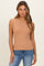 woman wearing a tan sleeveless ribbed top paired with blue jeans