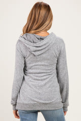 woman wearing a grey maternity hoodie with a relaxed fit and hood, showing the back view