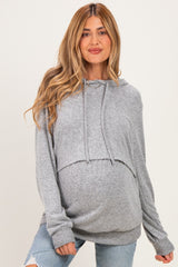 woman wearing a gray maternity hoodie with a cropped design and a visible baby bump