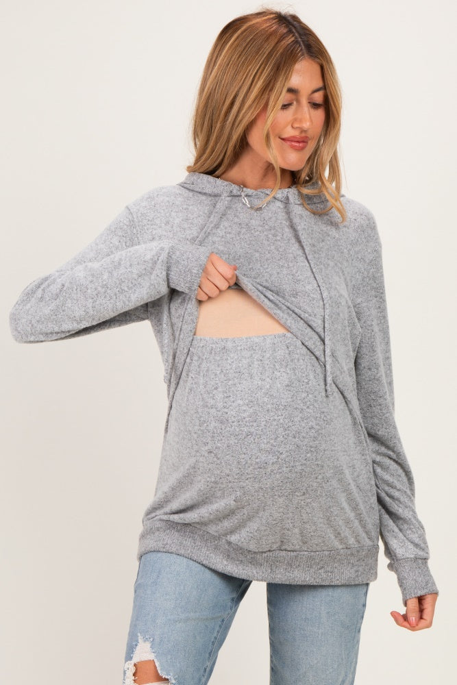 woman wearing a gray maternity hoodie with a front opening for easy access and showing her baby bump