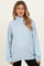 woman wearing a light blue maternity pullover sweatshirt with a high collar and long sleeves