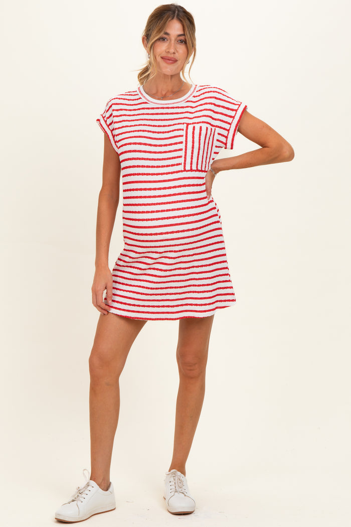 woman wearing a red and white striped maternity dress with a pocket and short sleeves