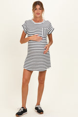 woman wearing a black and white striped maternity dress and holding her baby bump