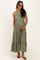 woman wearing a dark green maternity maxi dress with ruffle details and pockets, showcasing her baby bump