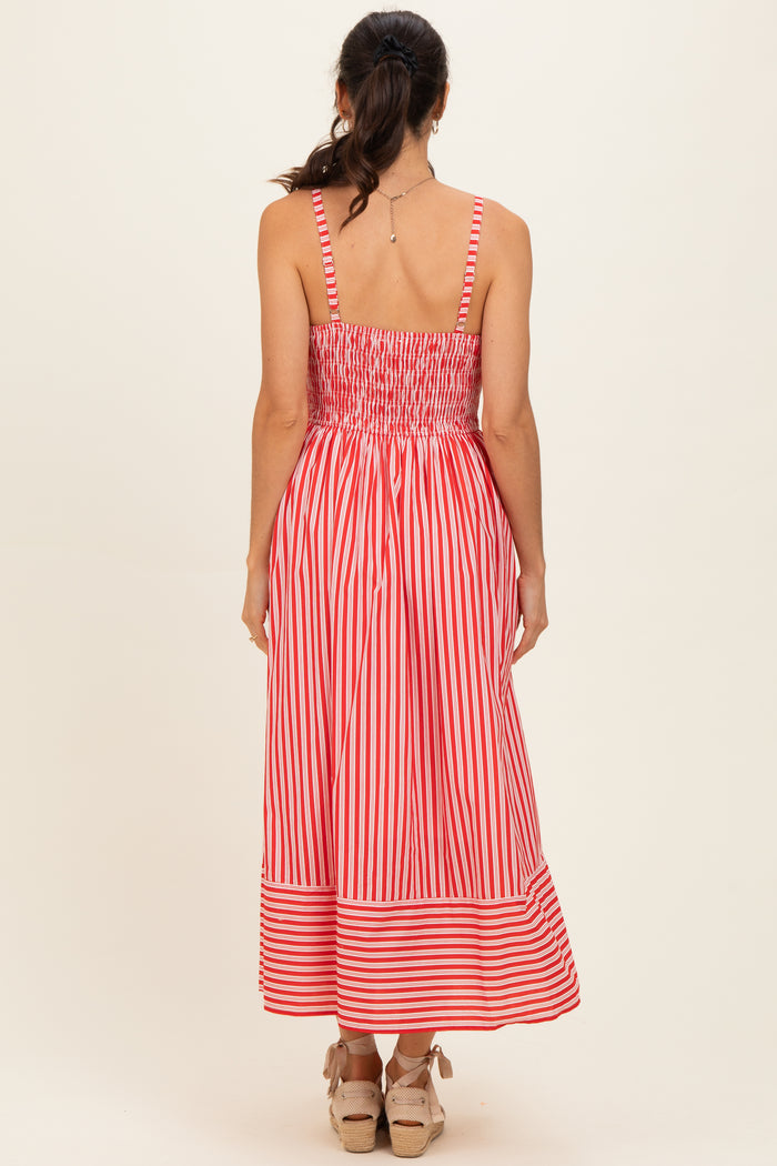 woman wearing a red and white striped midi dress with a smocked bodice and an open back view