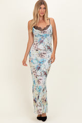 woman wearing a fitted maxi dress with a colorful floral print and lace detailing at the neckline