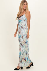 woman wearing a floral print maxi dress with lace detailing and a fitted silhouette, standing sideways