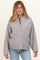 woman wearing a light gray maternity fleece jacket with a button-up front and contrasting trim