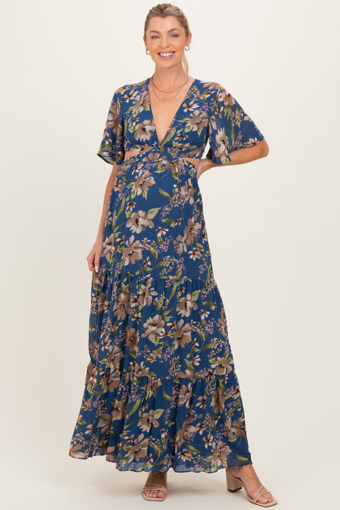 woman wearing a floral print maternity maxi dress with a deep v-neck and short sleeves, showcasing her baby bump