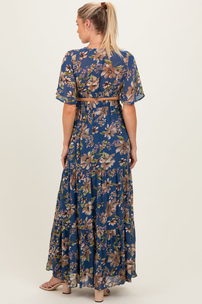 woman wearing a floral maxi maternity dress with short sleeves and a belt, showing the back view