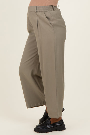 woman wearing light beige maternity wide-leg pants with an elastic waistband and side pockets