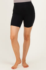 woman wearing black maternity bike shorts with a high waistband and fitted design