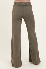 woman wearing olive green maternity wide-leg pants with a smocked waistband, showing the back view