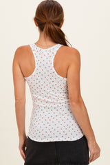 woman wearing a white maternity tank top with a floral print, showing a fitted silhouette from the back