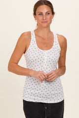 woman wearing a white maternity tank top with floral print and button details