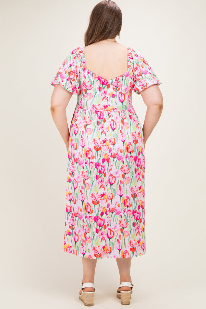 woman wearing a floral print maternity dress with short sleeves, showing the back view and a comfortable loose fit