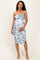 woman wearing a blue and white floral maternity dress with a fitted silhouette and a baby bump