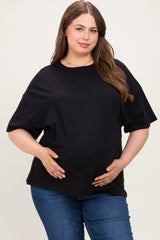 woman wearing a black maternity plus oversized t-shirt and holding her baby bump